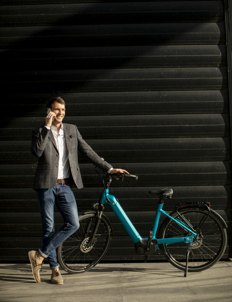 young businessman standing by the ebike and using 2022 04 19 01 52 57 utc